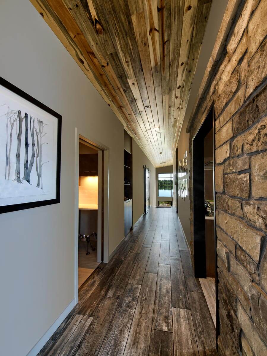 Custom home hallway with beetlekill pine on the ceiling by Hammersmith Structures, Fort Collins CO